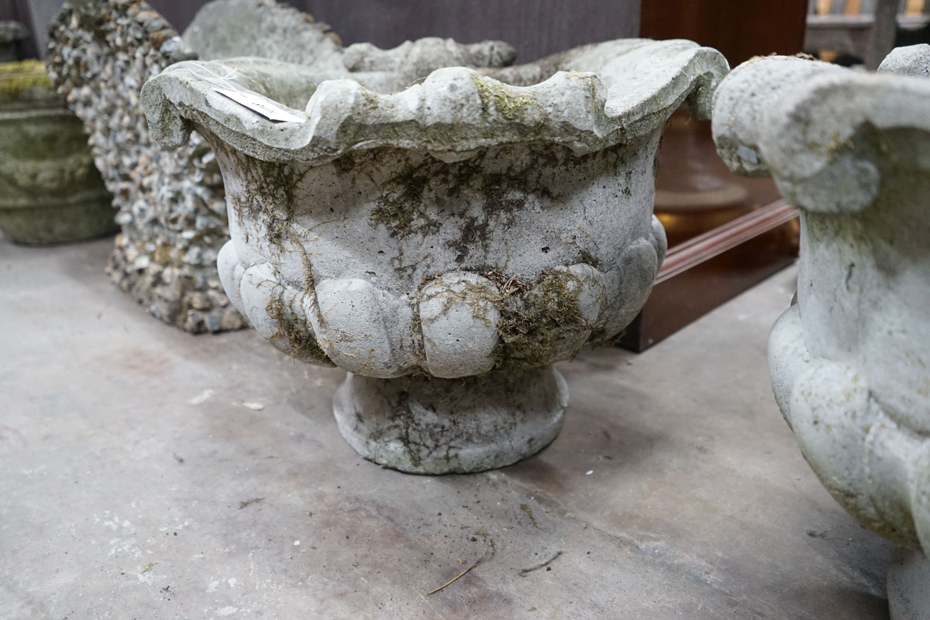 A pair of circular reconstituted stone fluted garden planters, diameter 52cm, height 39cm